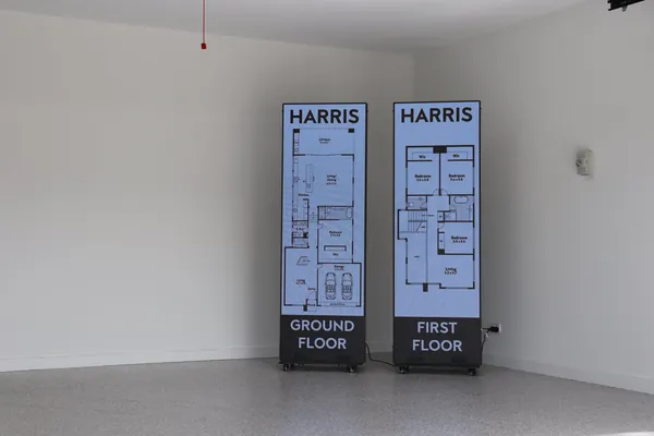 Pair of indoor LED poster screens displaying Harris floor plans